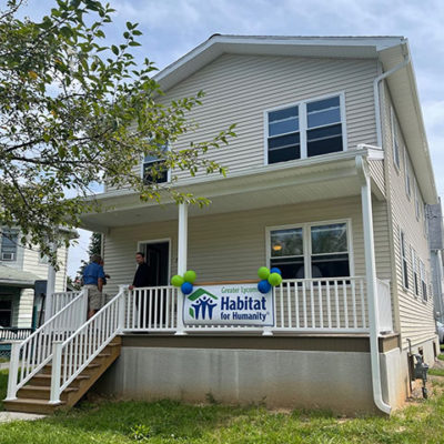 The Matthews family's new home in the city's Newberry section is dedicated during an Aug. 3 ceremony attended by Penn College co-workers.