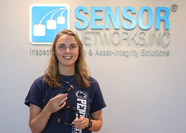 Pennsylvania College of Technology graduate Natalie J. Rhoades, a native of Weedville, holds the SensorScan DHT-400 ultrasonic transducer, which she recently designed for Sensor Networks Inc. Rhoades is an applications engineer for the State College-based company. SNI is marketing the transducer to the oil and gas and power generation industries. An honors student, Rhoades graduated in 2020 with a bachelor’s degree in welding and fabrication engineering technology and an associate degree in welding technology. (Photo provided by Sensor Networks Inc.)