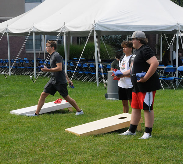 A cornhole tournament outside Dauphin Hall provides a popular venture.