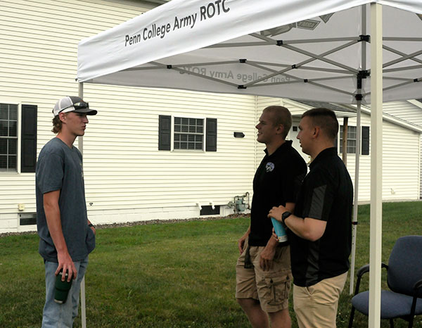 Jansen L. Balmer, of Ephrata, a residential construction technology and management major, talks with two cadets outside the ROTC House: Gabriel R. Kennedy-Citeroni (center), a civil engineering technology student from Blairsville, and Joshua E. Norris, a human services and restorative justice major from Gratz.