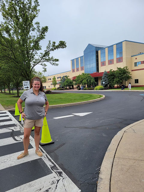 Human resources generalist Kait E. Sellinger is among the friendly faces greeting newcomers outside the Bush Campus Center.