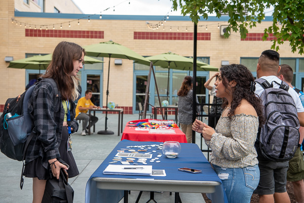 Angelyvette Santana (right), president of the One World Club, discusses her organization’s mission with Madison N. Sweeney, a graphic design freshman from Lewistown. Santana, from Scranton, is enrolled in radiography.