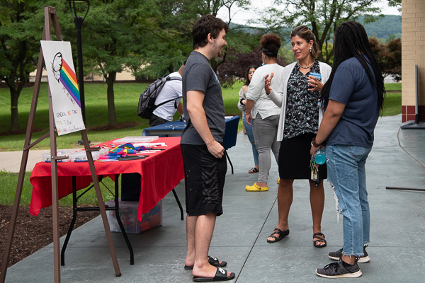 Kathy W. Zakarian (center), director of counseling, chats with students attending the midday, late-summer soiree. 