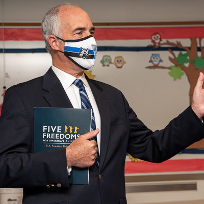 Holding his "Five Freedoms" folder, the senator speaks to a Williamsport Sun-Gazette reporter.