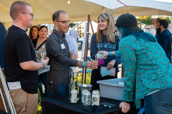 Alumni line up to enjoy Terrapin Beer, a company based in Athens, Ga., that hired Montana L. Bilbay (at right, serving), a 2021 brewing & fermentation science graduate. From left: Adam H. Lester, ’02, electronics engineering technology; Mark R. Capellazzi, ’09, culinary  arts & systems; Katie L. Mackey, ’02, applied human services. Lester and Capellazzi are former Presidential Student Ambassadors. Mackey is employed at the college as assistant director of disability and access resources.