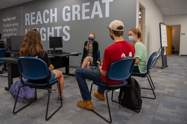 Admissions counselor Maddie L. Metzger (center) takes advantage of the collaborative space to meet with first-year students she recruited months ago.