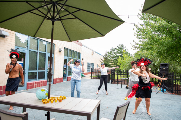 Mika (at left, with microphone) offers good-natured commentary as Tiffany instructively leads a dance party on the patio ...