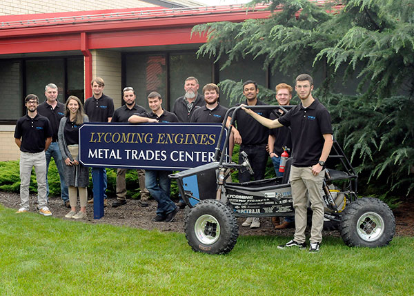 Lycoming Engines, a longtime partner of Pennsylvania College of Technology, offers financial support to a student organization competing in a prestigious off-road racing venue: the Baja SAE Club. From left are Dominic J. Lepri, of Monroe Township, N.J.; John G. Upcraft, instructor of machine tool technology/automated manufacturing and faculty adviser; Morgan R. Bagenstose, of Reading; Tyler J. Bandle, Slatington; alumnus Tyler McCoy, Lycoming Engines' manufacturing engineering manager; Arjun L. Kempe, of Perkasie; James Wright, senior manager of operations at Lycoming Engines; Caleb J. Harvey, of Elmer, N.J.; Dhruv Singh, of Dayton, N.J.; Marshall W. Fowler, of Perkasie; and Dakota C. Harrison, of Lewisberry. The company also served as a sponsor for the Penn College Spring 2021 Car Show.