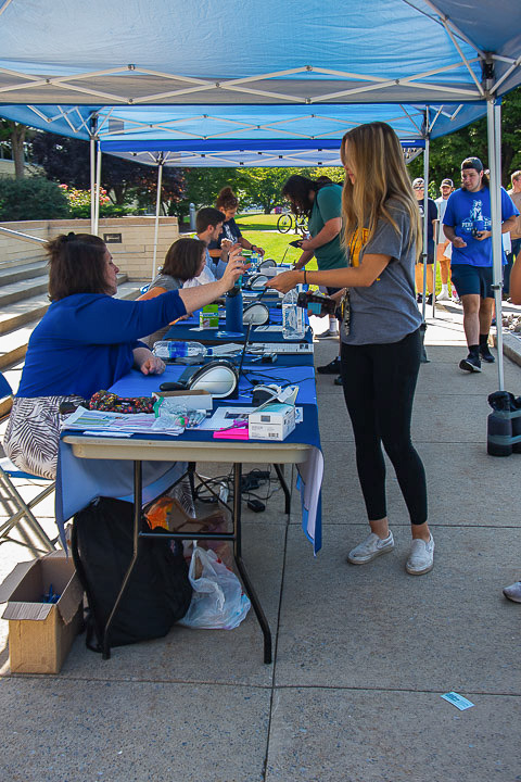 Allison A. Grove (seated), director of student engagement, registers a First Year Experience student at the Fall Fusion/Part-Time Job Fair sign-in table. FYE classes, asked to obtain signatures from booths of their choosing to prove they attended the event, were also encouraged to ask questions about student organizations and job opportunities to make on- and off-campus connections.