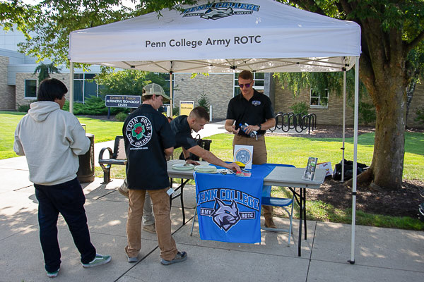 Penn College's ROTC program, part of the Bald Eagle Battalion, draws some interest in the shade of its tent.
