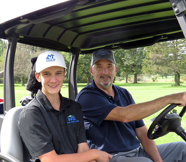 Ronald Z. Miller – Penn College retiree, alumnus and scholarship donor – was accompanied by son Evan as part of a family foursome.