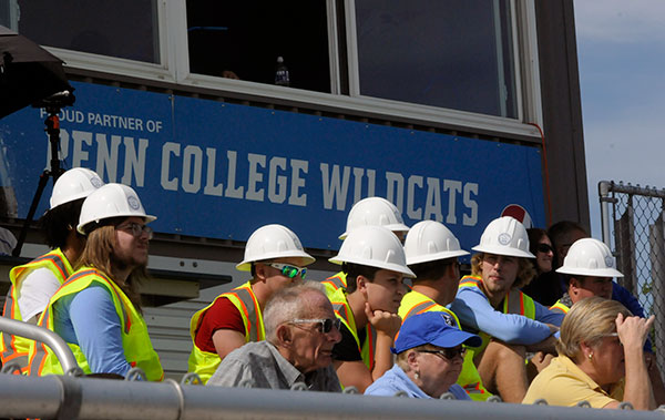 In safety vests and hard hats, construction management students support Wildcat Athletics while proudly representing their major.