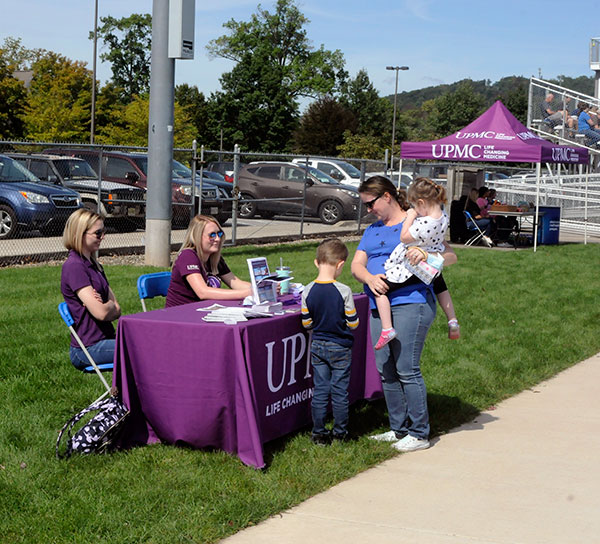 Fittingly seated near the entrance to UPMC Field, health care recruiters interact with attendees at Saturday's soccer doubleheader.