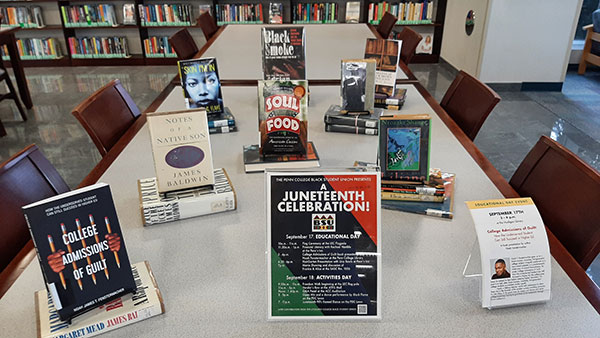 Madigan Library set up a table of related books near its main circulation desk, including 
