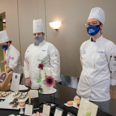 Inside the dining hall, from right, are CC N. Hawkins, of Williamsport, with Vanille Specialty Desserts (featuring lemon raspberry cupcakes, white chocolate cranberry macarons and pistachio frangipane tartlets); Zachery A. Deibler, of Annville, with Zack’s Brownies; and Sarah Wolf, of White Haven, with Wolf de Patisserie (pastry wolf).