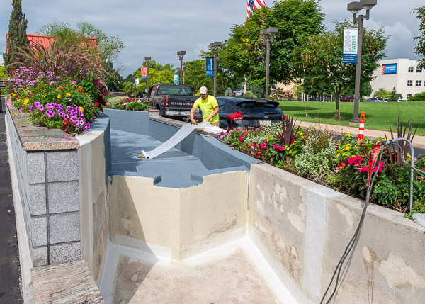 Waterproofing material is trimmed for application, increasing the durability and lifespan of a gateway gem.