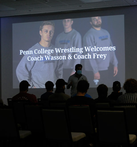 Only the third wrestling coach in the institution's history, Miller asks current team members to 