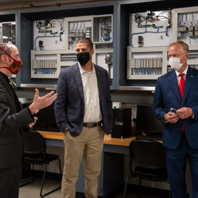 Webb (left) talks with Owlett (center) and Keller in an electrical lab.