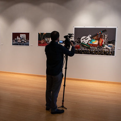 An array of technology is visible – including in the hands of Adam J. Miller, manager of instructional media production, who captures footage of the exhibit.
