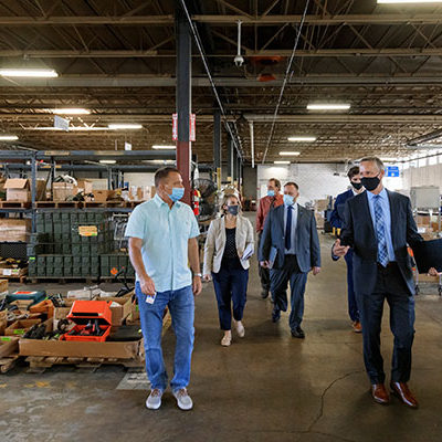 The group tours DGS' federal surplus warehouse, led by Michael Starr, chief of federal surplus and law enforcement property.