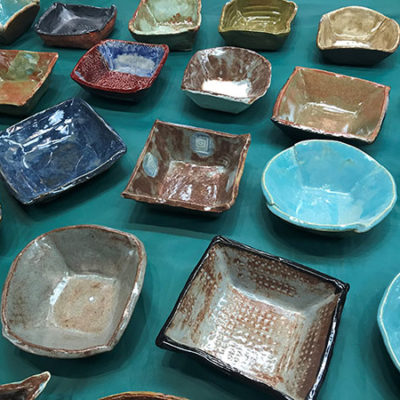 Ceramics classmates' uniquely crafted bowls add local color to the green of a Bush Campus Center pool table.