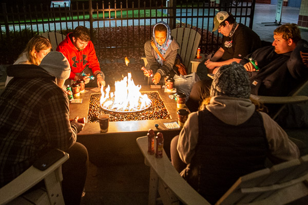 Participants cozy up for bingo around the CC fire pit, with ARW Thrift Stores gift cards as prizes.