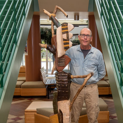 David A. Stabley, instructor of ceramics and wood sculpture, with his untitled sculpture