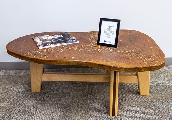 A modern concrete coffee table created by construction alumni Joseph F. DiBucci, '18 and ’20, and Matthew E. Blose, ’19, features exposed river-gravel veining and a maple-and-walnut base.