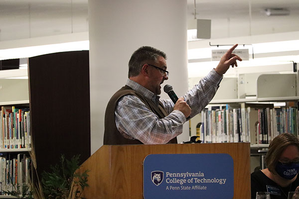 Roan's experienced eye acknowledges another bidder in the crowd.