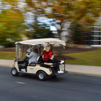 The "Cash Cab" makes another loop, whizzing past Madigan Library in an autumnal blur.