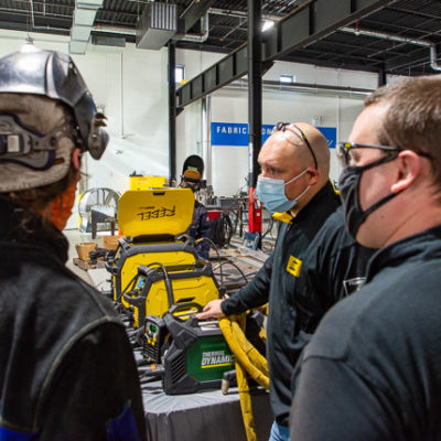 Penn College welding alum Jason M. Brown (far right) returns to campus as a field marketing specialist for ESAB. He’s joined by the company’s regional sales account manager, Rob Mitchel.