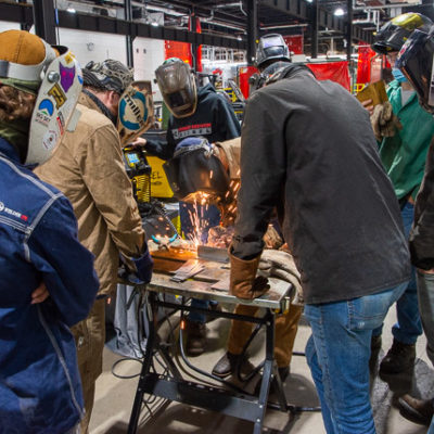 The students employ gas metal arc welding to test the ESAB Rebel power supply.