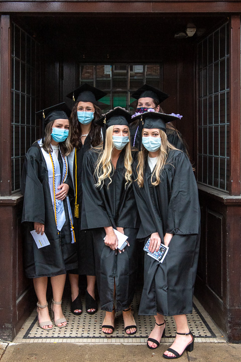 Nursing students catch cover in an alcove along the processional route.