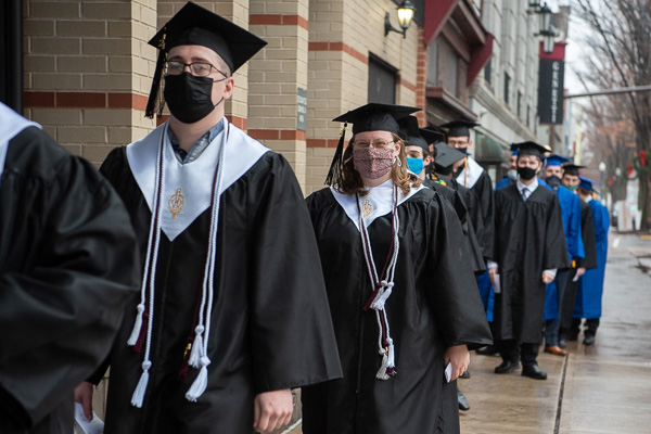 Students' white stoles signify their membership in the Alpha Chi baccalaureate honor society.