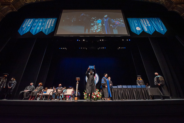 Alane D. Zellars exults in accomplishment, holding aloft proof of her bachelor's in human services and restorative justice. She completed her associate degree in the same field in 2019.
