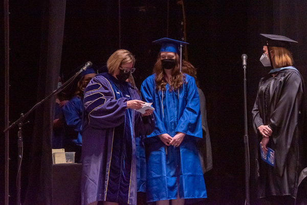 Carolyn R. Strickland, vice president for enrollment management and associate provost, smooths each graduate's triumphant rite of passage – painstakingly ensuring proper pronunciation while maintaining on-stage traffic control.