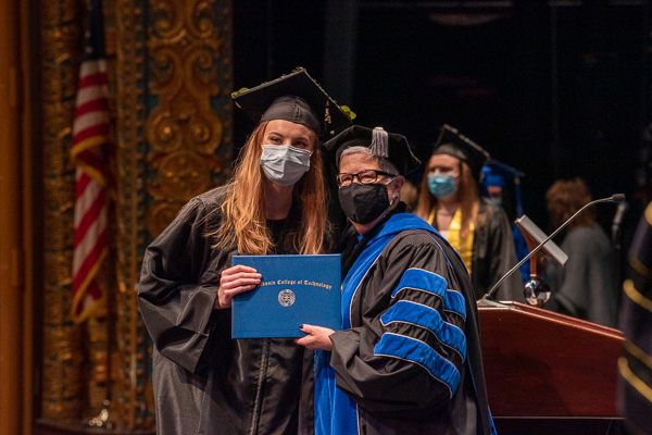 One of the creatively inclined alumnae who adorned their caps, Ashley E.J. Snyder takes her turn in the spotlight as an in-demand nurse.