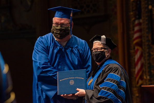 Exemplifying lifelong learning and a passion for critical care is Torrence W. Englert Jr., sealing his nursing degree with a presidential handshake.