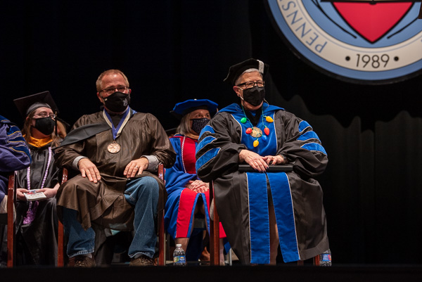 Sones may have his Master Teacher medal, but Gilmour has her battery-operated Christmas bulb necklace! The president donned the colorful accessory to maintain the festive tradition of now-retired Chef Paul Mach (the college's 2001 Master Teacher), who annually wore a Santa hat to commencement.