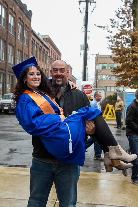 Izabel P. Ramer, who graduated in the two-year business management major, gets a little lift from Dad.