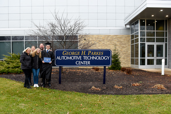 Among the rare few who braved the chilly, rainy weather for postceremony photos on campus is the family of automotive technology management grad Andrew P. Luzeckyj Jr., returning to a building that played a significant role in his Penn College days. 