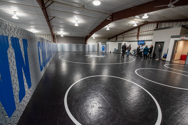 The tour group (led by Gilmour, Strickland and Loni N. Kline, vice president for college relations/chief philanthropy officer) enters the newly renovated second-floor wrestling practice space in the Field House.