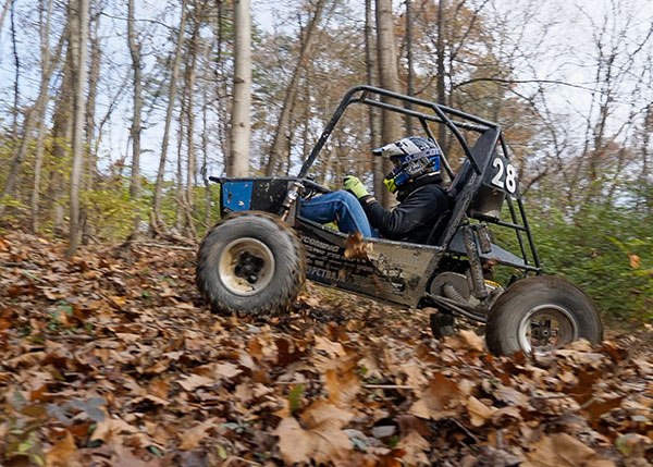 Tyler J. Bandle, of Slatington, majoring in automated manufacturing technology at Pennsylvania College of Technology, drives the school’s Baja SAE car through a test track cleared by heavy construction equipment technology students. The rugged track at the college’s operations training site replicates conditions the team will face during the endurance race at Baja SAE competitions in 2022. 