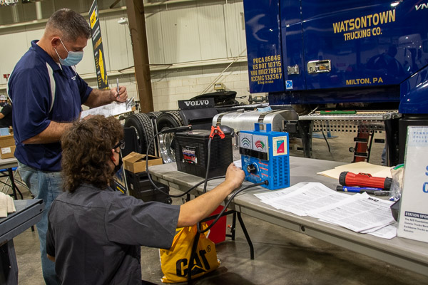 A representative from Watsontown Trucking Co. provides judging assistance at the starting and charging station.