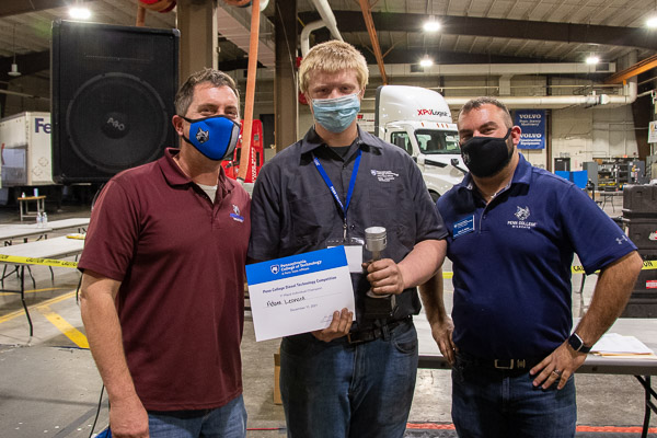 Adam Leonard (center) won a $10,000 Penn College scholarship as the top finisher. He poses with Chris S. Weaver (left), assistant professor of diesel equipment technology, and John D. Motto, instructor of diesel equipment technology. Leonard is a student at Northern Tier Career Center.