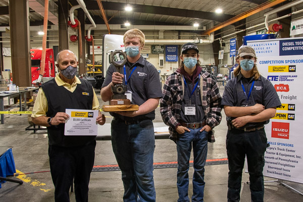 Competitors from Northern Tier Career Center – which won first place overall in the competition – accept a traveling trophy and certificate from Cleveland Brothers Equipment Co. Inc. representative Doug Wetzel (left).