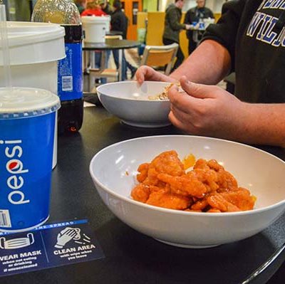Applied management student Kellor A. Schooley, of Turbotville, digs into a bowl of saucy goodness while talking with Thomas C. DeGeyter, a residential construction technology and management student from Long Valley, N.J.