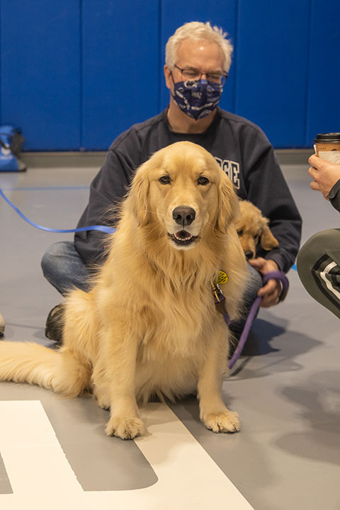 Regulars at the event – Drew R. Potts, assistant professor of civil engineering technology, and his golden retriever, Winnie – brought along the newest member of the family: Indy, destined not to be in the background for long.