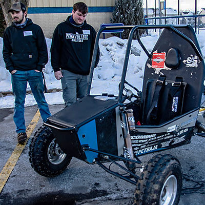 Confirming the Baja SAE vehicle's all-terrain versatility, teammates – each of them pursuing a bachelor's degree in manufacturing engineering technology – take to the snowy outdoors: Isaac H. Thollot (left), a first-year club member from Milford, and Caleb J. Harvey, a senior member from Pittsgrove, N.J.