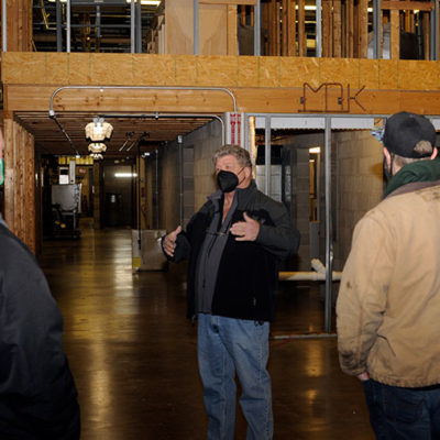 Marc E. Bridgens, associate professor of HVAC technology, leads a lab tour in the Carl Building Technologies Center. (A second group was assigned to Kenneth E. Welker, instructor of plumbing and heating.)